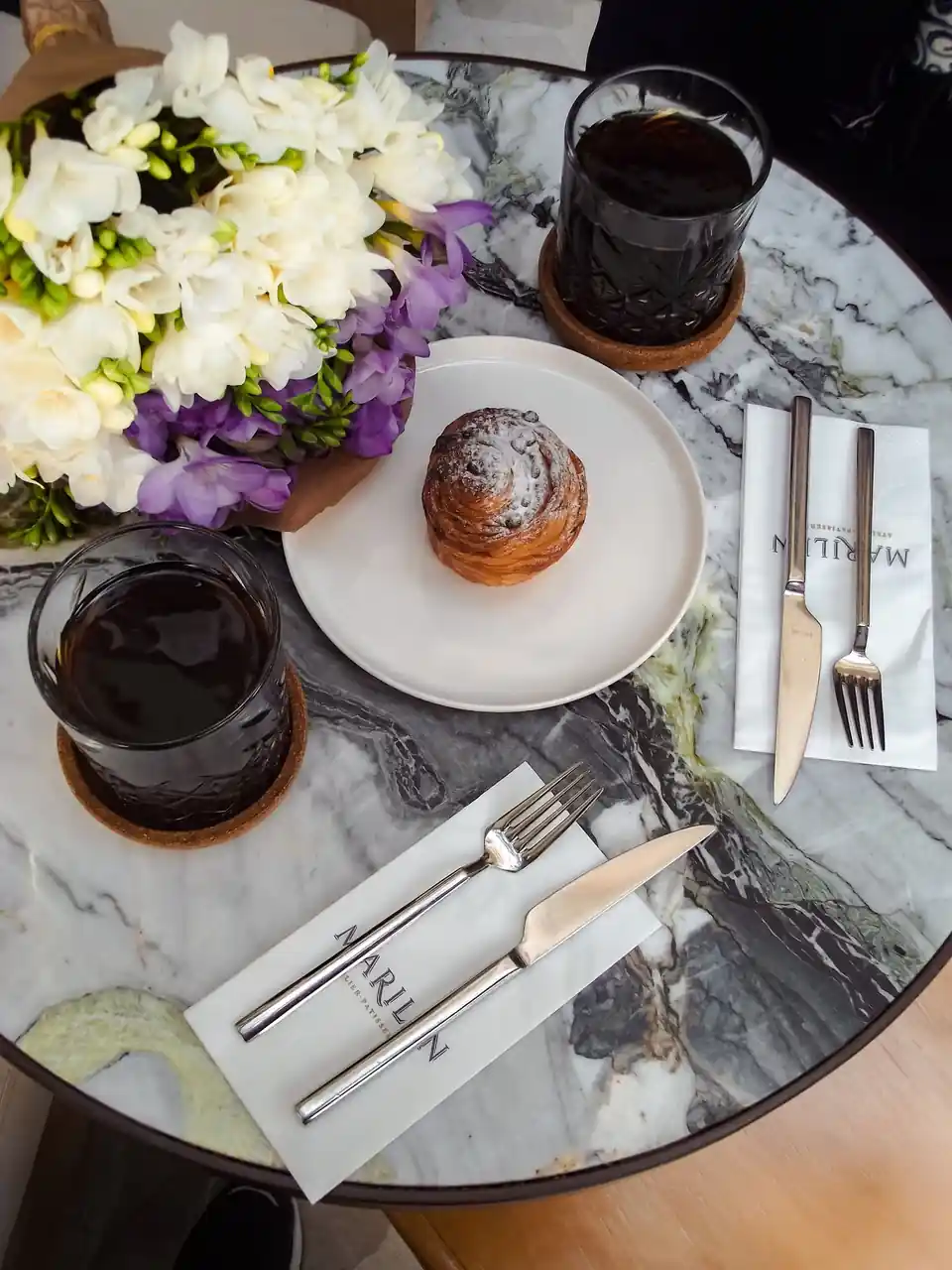 Sophisticated marble tabletop setting with floral notes and refined decor