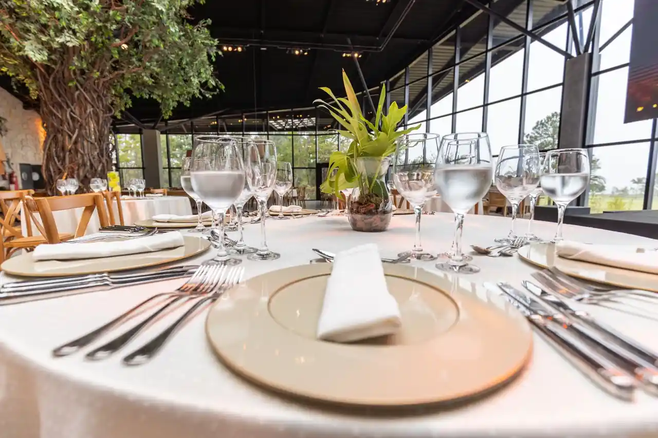 Elegant table arrangement with modern glassware, porcelain plates, and botanical accents