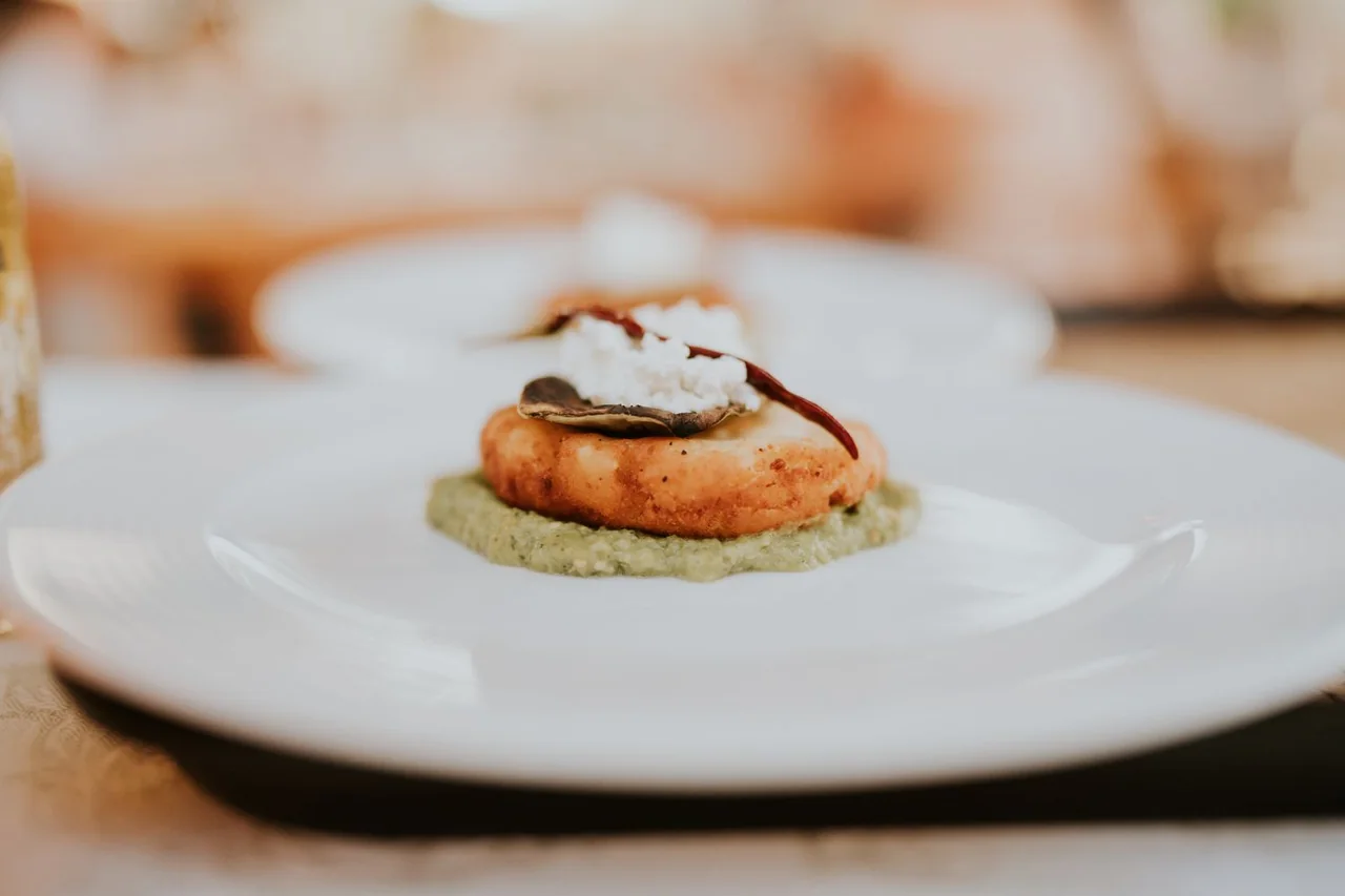 Gourmet starter with delicate crisp tuile and emulsion on pristine white porcelain