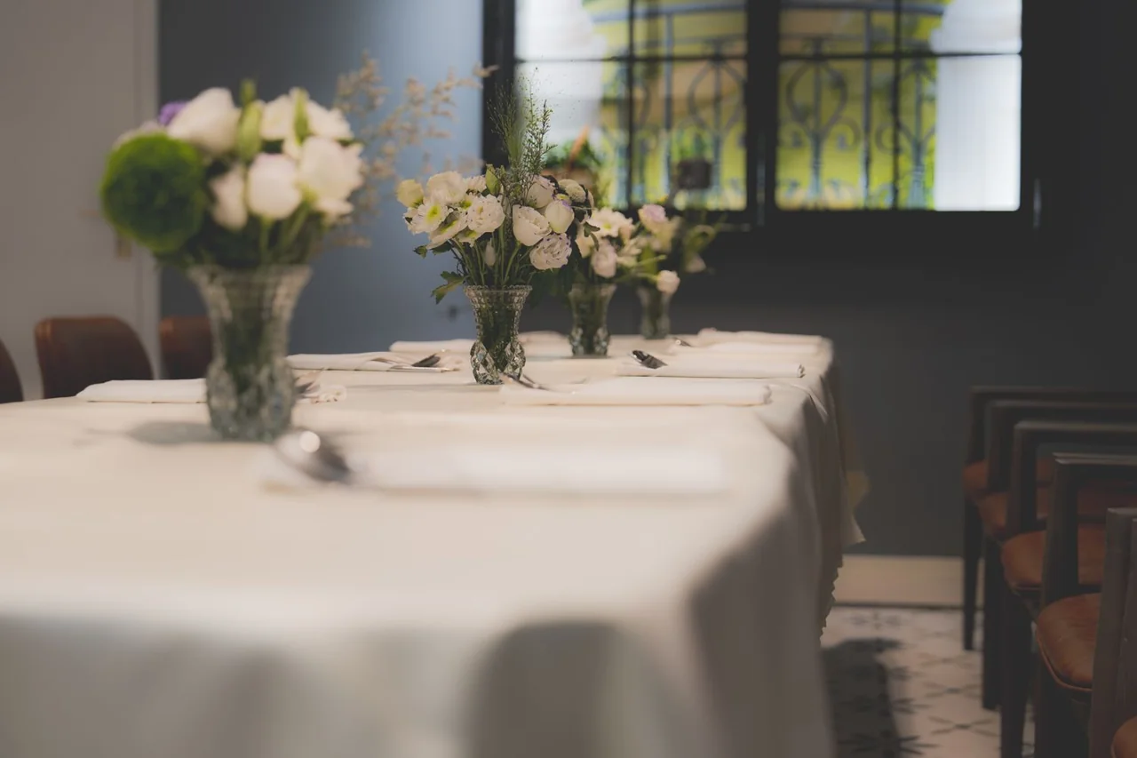 Sophisticated private dining setup featuring fine linens and artisanal floral arrangements
