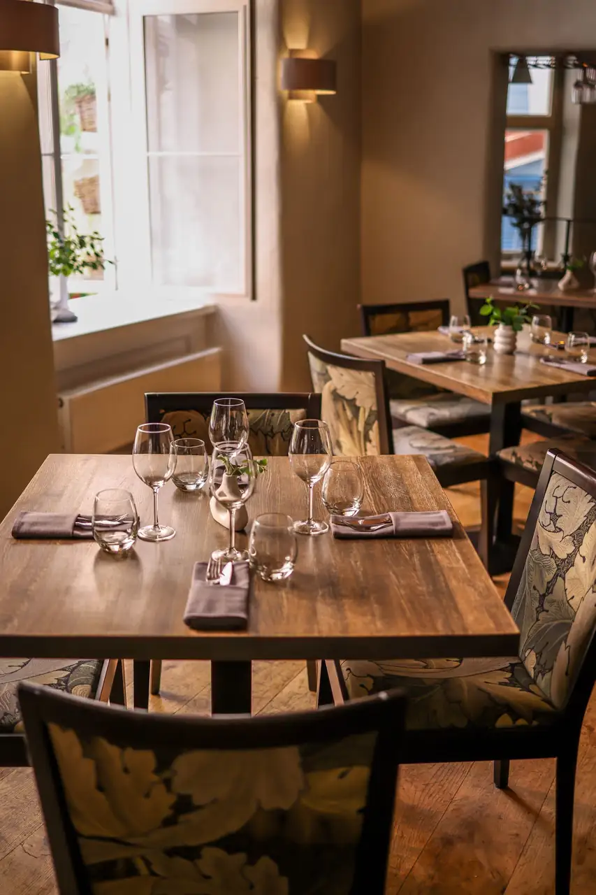 Intimate private dining salon with dark acoustic walls and warm lighting