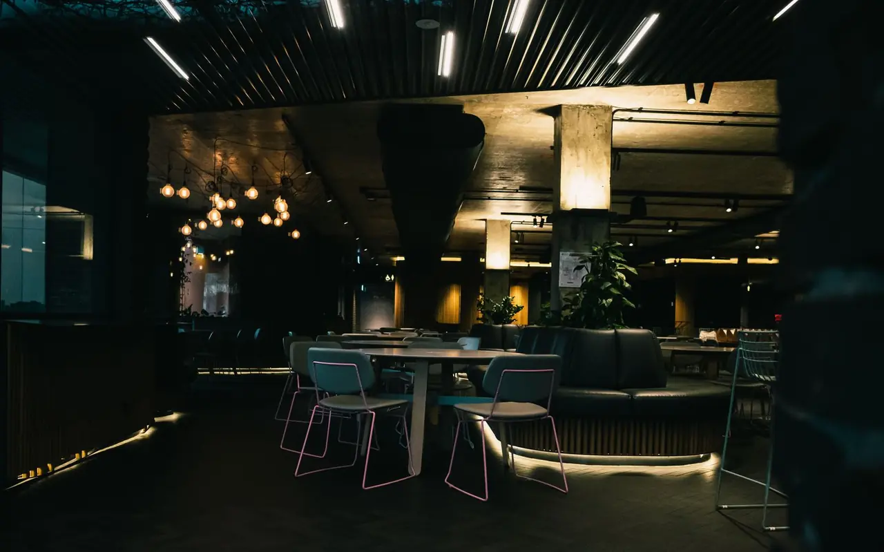 Contemporary dining hall and lounge interior with warm ambient illumination