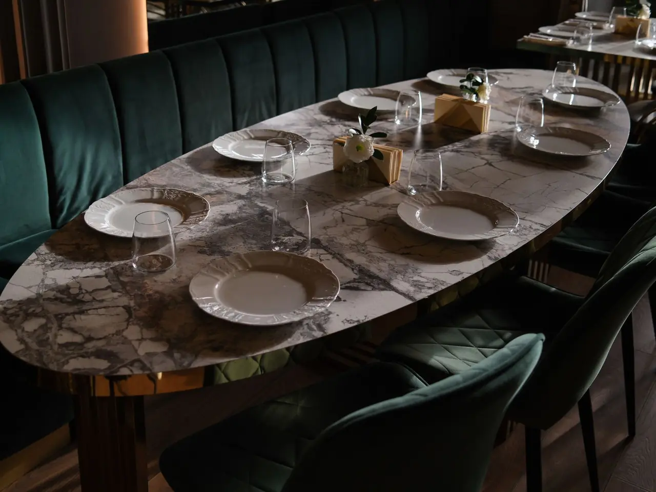 Refined marble dining table with elegant porcelain plates and modern glassware