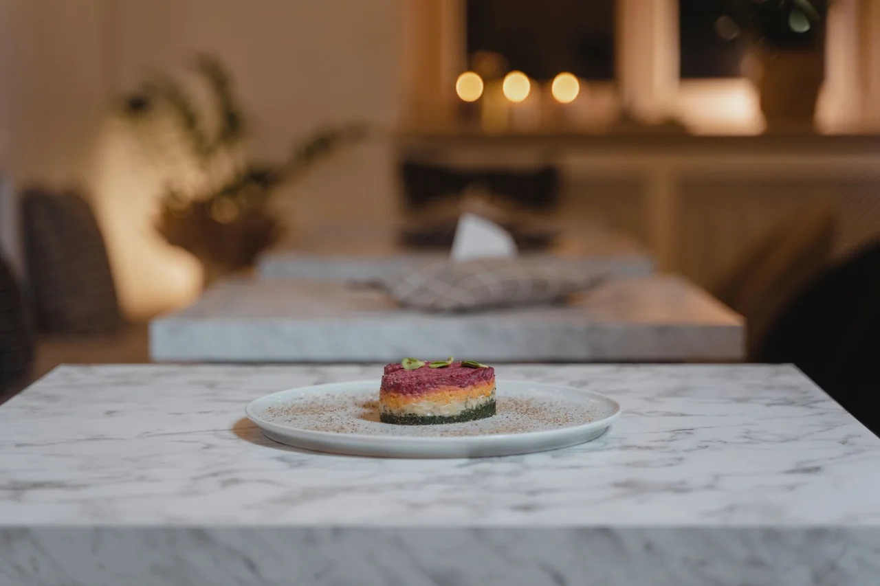 Refined contemporary cuisine plated artfully on marble tableware at Zelvari Cuisine Hall
